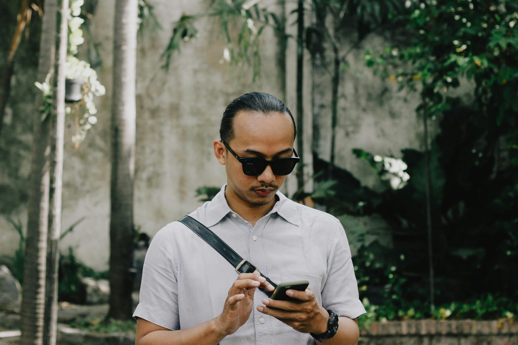 Người đàn ông cầm điện thoại kiểm tra thông tin vay online