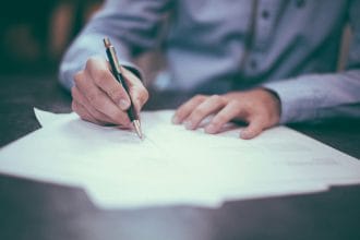 Tư vấn viên bảo hiểm trao đổi hợp đồng nhân thọ với khách hàng